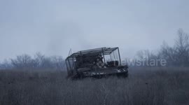 Russian military servicemen tow away broken-down armoured vehicle for repair