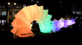 People interact with an amazing colour-changing 9-metre-long robotic snail in London