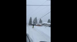 Coquitlam local embraces rare 35 cm snowfall with street skiing adventure