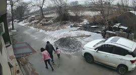 Young family laugh away accidental slip on icy doorstep