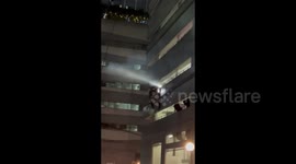 Drunken reversal: car hangs on edge of Makati office building after bizarre accident