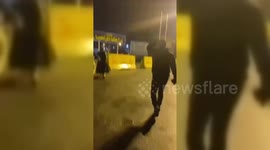 Family of Iranian protester Masoumeh Ahmadi grieve at the gates of Qazalhasar prison in Karaj, Iran