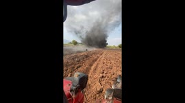 Cataclysmic dust devil tornado whips up dirt as farmer ploughs field