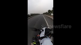 Woman on Motorcycle Dodges Falling Cargo on Highway in Nanjing, China