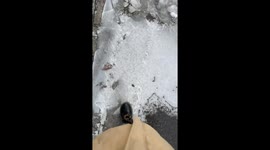 Woman's ASMR video stepping on thin ice on road fails when she slips down