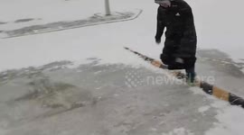 Chinese teenagers slip while trying to slide on icy road
