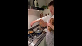 Multi-tasking mastery: cooking with a pawsome companion in Mierlo, Netherlands