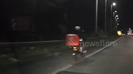 Crazy! Just Eat CYCLIST haplessly pedals onto the M6 Motorway near Birmingham’s Spaghetti Junction