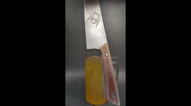 Dipping the honeycomb handle of my freshly made knife in Tung oil.