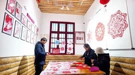 Intricate zodiac dragon paper decorations cut out ahead of Chinese New Year