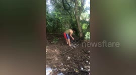 Kind resident helps free snake entangled in net in backyard