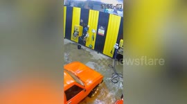 Dad hoses down daughter's toy car at self-service car wash in Thailand