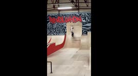 Skateboarding on a big rail. The trick is called a ‘boardslide’ both up and down the rail.