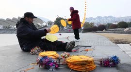 Old Couple Fly Dragon-shaped Kites in Nantong, China