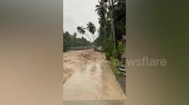 Flash flood gushes through river and erodes parts of road at village in the Philippines