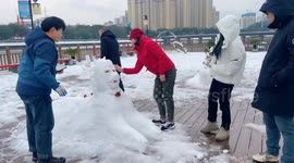 People Come Outdoors To Make A Snowman in Yichang, China