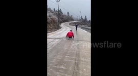 Skating on feet on the icy road in Zhangjiajie, China