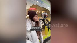 Moment shocked young busker gets 