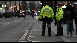Cyclists riding past Police who are protecting due to the war between Palestine and Israel