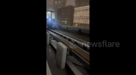 Japan: Passengers Walk On Tracks After Train Stranded Due To Heavy Snow In Tokyo 2