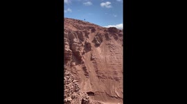 Riding Down A Steep Cliff Face