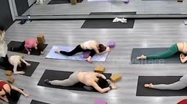 Woman's leg snaps while doing yoga pose when instructor presses on her back