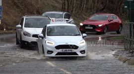 Learner driver shows how to safely navigate flooding as other drivers plough through without care in Birmingham