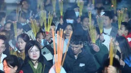 People flock to a temple to burn incense for the first prayer of the Lunar Year in Nanning