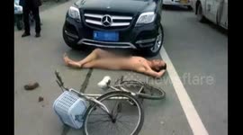 Naked man lies in front of car, pretending he was hit by it