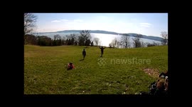 Drone captures stunning images of kids running down a hill in park