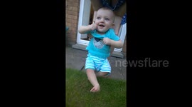 Our cute baby boy definitely doesn't want to put his feet on the grass!!!!!