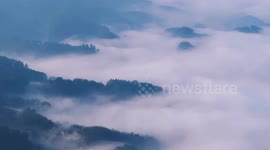 A Terraced Mountain Range Looms Under Advection Fog in Chongqing