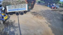 Kid sets fire to sugar cane stalks on back of truck causing chaos outside factory