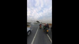 Motorcycle rider gets unexpected shower from road cleaning truck in Luxembourg