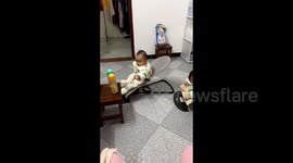 Smart baby ingeniously wiggles rocking chair to reach milk in China
