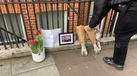 Supporters of Alexei Navalny leave fowers outside the Russian Embassy in London