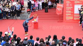 Tourists Watch a Folk Art Performance in Nanning, China