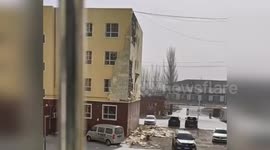 Powerful winds tear off building's outer during storm in China