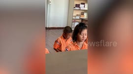 Boy can’t hold his laughter while meditating