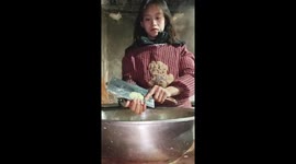 Chinese girl showcases excellent knife skills by shredding potatoes in hands