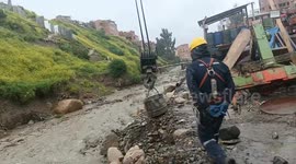 Bolivian workers use crane to rescue dog trapped in raging river