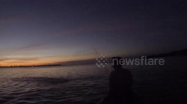 Tarpon almost jumps in fishermans canoe at dark! (in the Florida Keys)