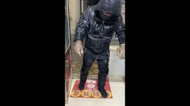 Man’s Clothes Covered in Ice after Riding Home in Freezing Rain in China