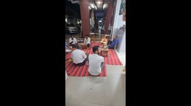 Hindu devotees singing devotional songs outside a garment selling shop in Margao city in the Indian state of Goa