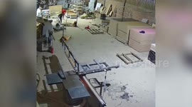 Two factory workers run for their lives as ceiling collapses behind them