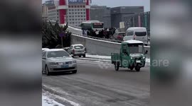 Passengers push bus uphill as it kept sliding down due to heavy snow