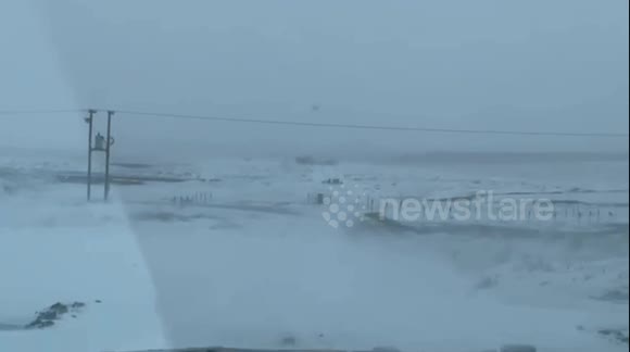 Road conditions. Truck plowing through snow banks on Saskatchewan roads