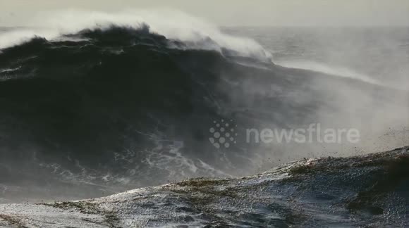 Brazilian surfer dwarfed as he conquers MONSTROUS wave in world record attempt