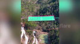Families with little children play on 650ft high mesh net football pitch