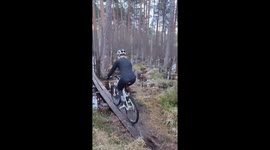 Woman takes risk on submerged bridge: video captures dramatic bike fall in flooded woods